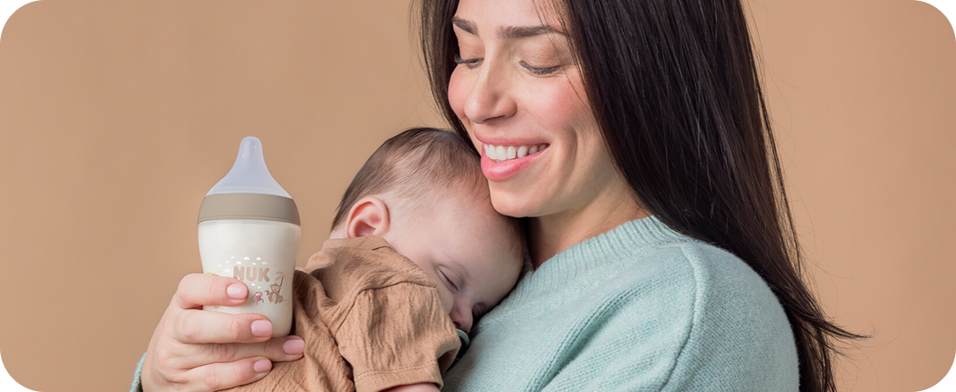 [Translate to Polish (Reborn):] Mother with Baby and Baby bottle