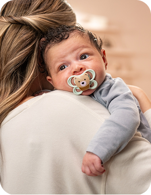 [Translate to Polish (Reborn):] Baby with soother