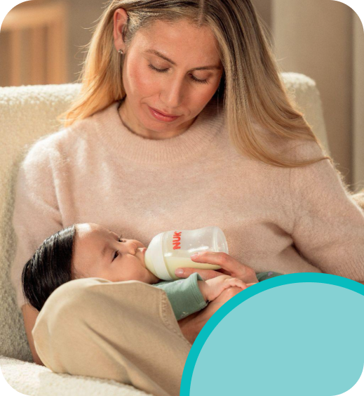 [Translate to Polish (Reborn):] Mother with Baby and Baby bottle