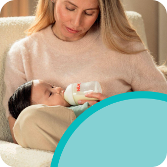 [Translate to Polish (Reborn):] Mother with Baby and Baby bottle